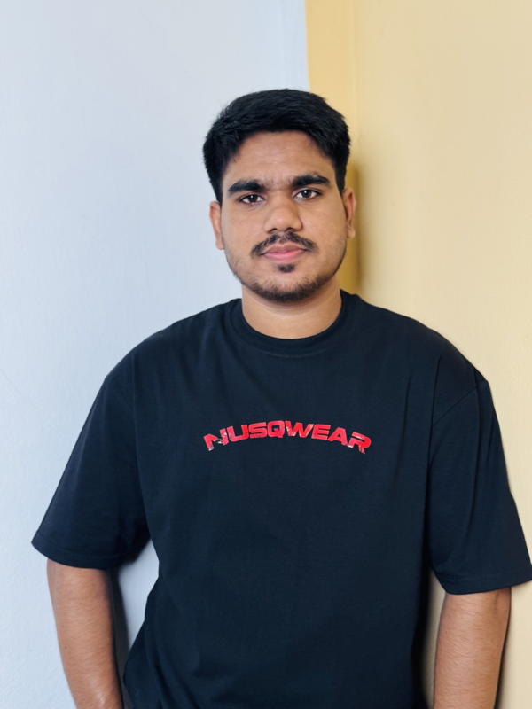 Young man wearing a black NUSQWEAR T-shirt with red logo.